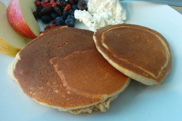 Stack of golden pancakes with berries