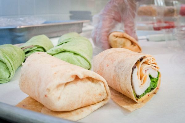 Chicken salad wrap cut in half on a plate