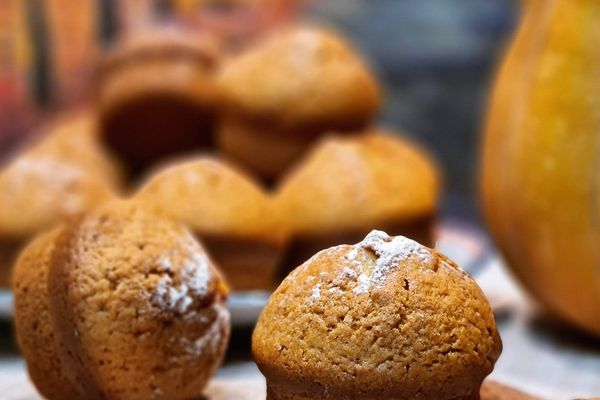 Pumpkin muffins on a table with cinnamon sticks
