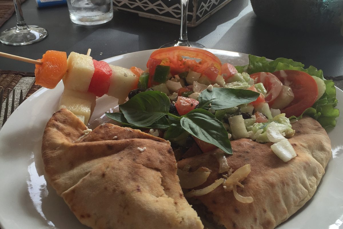 Stuffed pita pocket with salad on a plate